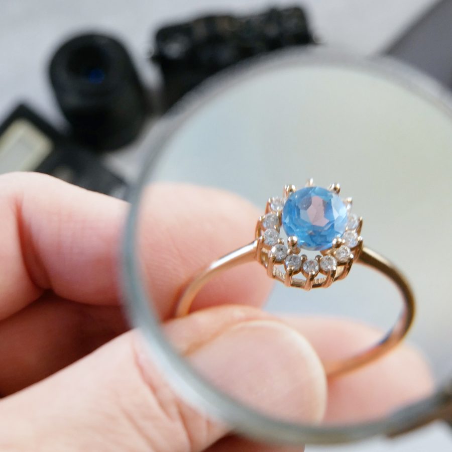 Jeweler,Looking,At,Ring,With,Blue,Stone,,Jewerly,Inspect,And